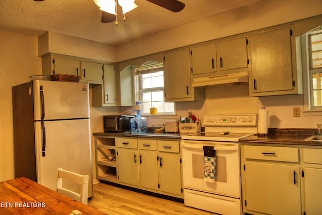 kitchen featuring a textured ceiling, stainless steel fridge, ceiling fan, white electric range, and light hardwood / wood-style flooring