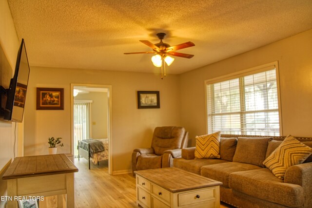 1010 Sheppard Rd, Jamestown, TN 38556 - living area featuring a textured ceiling, ceiling fan, light wood-style flooring, and baseboards