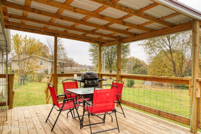 deck featuring area for grilling and a lawn