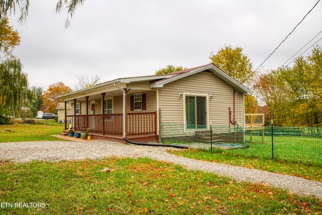 view of front of property with a porch and a front lawn