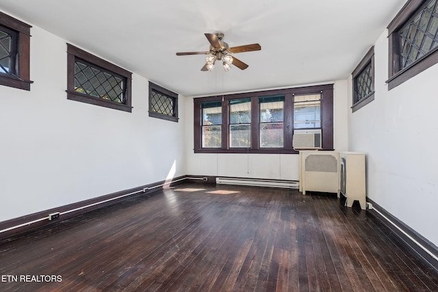 empty room featuring a baseboard radiator, cooling unit, dark hardwood / wood-style floors, and ceiling fan