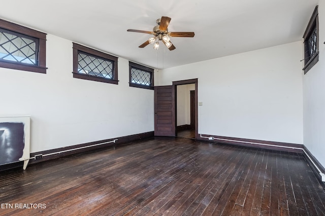 unfurnished room featuring ceiling fan and dark hardwood / wood-style flooring