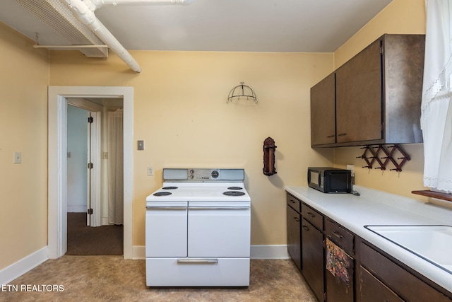 laundry area featuring sink and light colored carpet