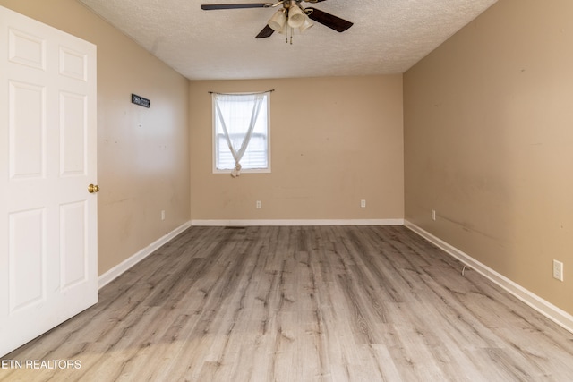 spare room with ceiling fan, a textured ceiling, and light hardwood / wood-style flooring