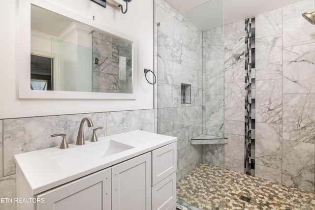 bathroom with vanity, tile walls, and a tile shower