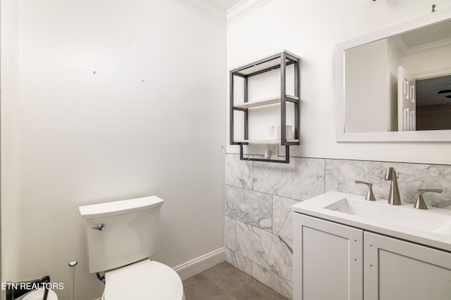 bathroom featuring tile walls, toilet, vanity, crown molding, and tile patterned floors