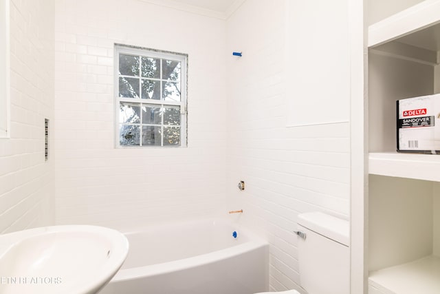 bathroom with toilet, crown molding, and sink