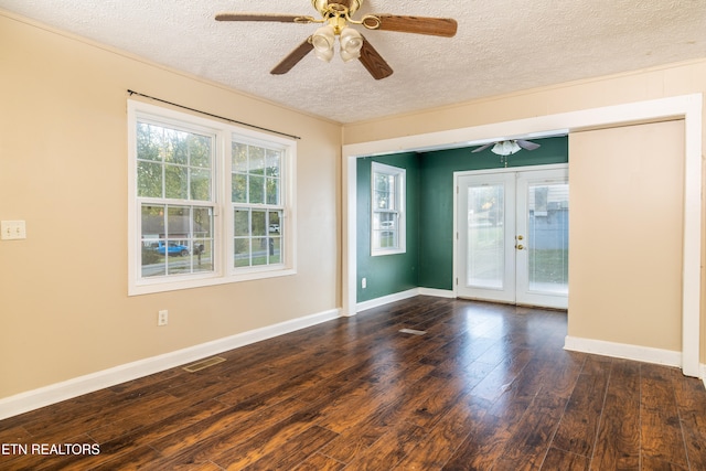 empty room featuring french doors, ceiling fan, a textured ceiling, and dark hardwood / wood-style floors