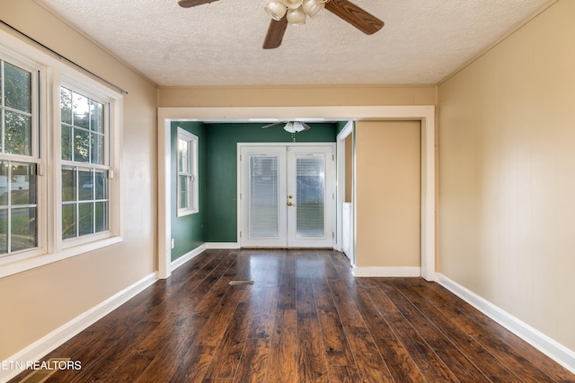 spare room with french doors, ceiling fan, a textured ceiling, and dark hardwood / wood-style floors