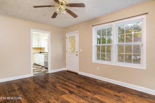 unfurnished room with ceiling fan, a textured ceiling, and dark hardwood / wood-style floors