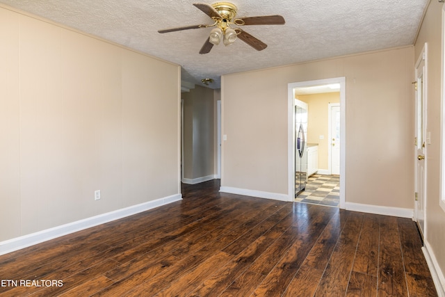 spare room featuring a textured ceiling, dark hardwood / wood-style floors, and ceiling fan