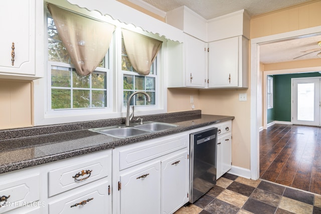 kitchen featuring a wealth of natural light, dishwasher, white cabinets, and dark hardwood / wood-style floors