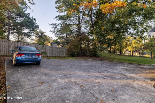 view of car parking featuring a yard