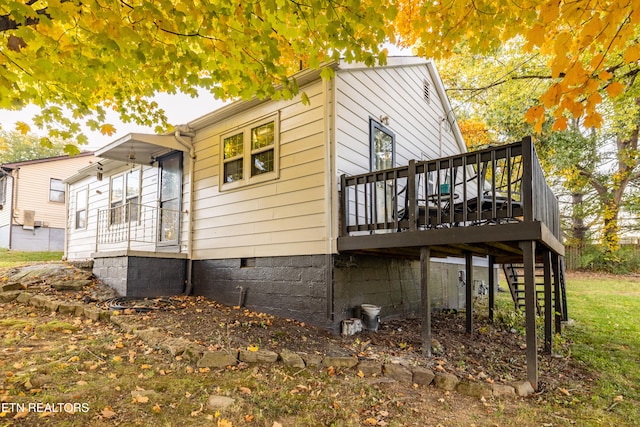 view of property exterior with a deck