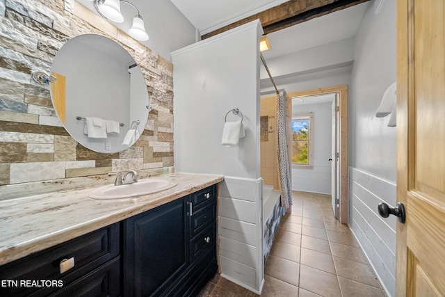 bathroom with tile walls, vanity, tile patterned flooring, and shower / bath combo with shower curtain