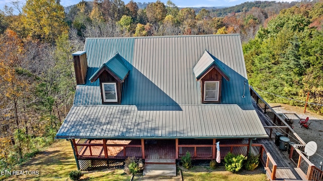 back of house featuring central air condition unit and a wooden deck