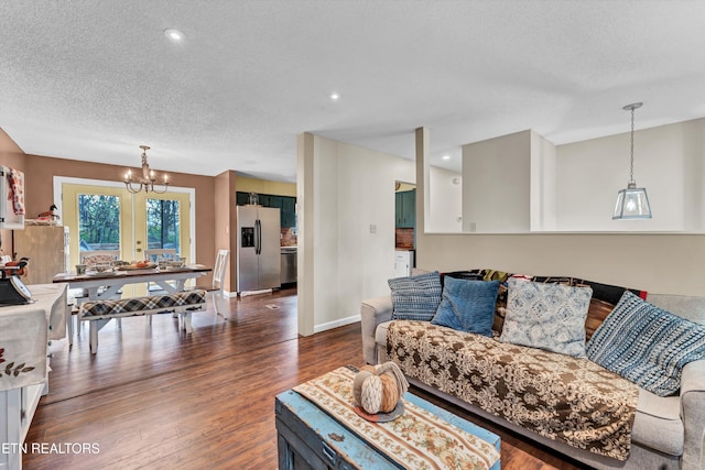 living room with french doors, hardwood / wood-style flooring, a textured ceiling, and a chandelier