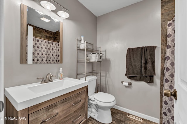 bathroom featuring vanity, hardwood / wood-style floors, and toilet