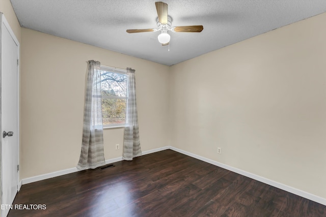 empty room with dark hardwood / wood-style floors, a textured ceiling, and ceiling fan