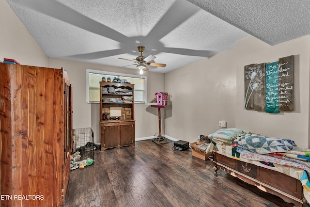 bedroom with dark wood-type flooring, a textured ceiling, and ceiling fan