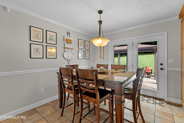 dining area featuring crown molding, a textured ceiling, and light tile patterned floors