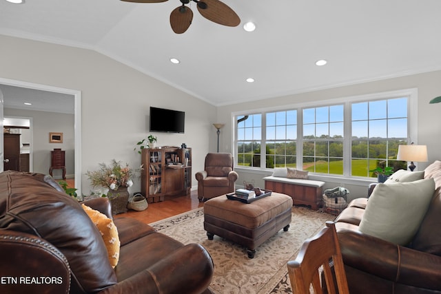 living room featuring light hardwood / wood-style floors, lofted ceiling, ornamental molding, and ceiling fan