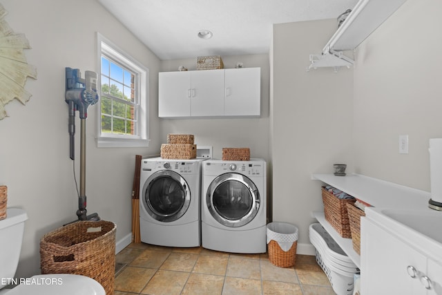 washroom featuring cabinets and washer and dryer