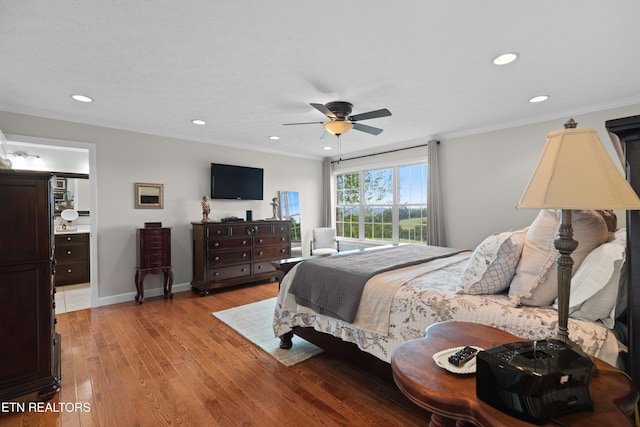 bedroom featuring ceiling fan, ornamental molding, ensuite bathroom, and light hardwood / wood-style floors