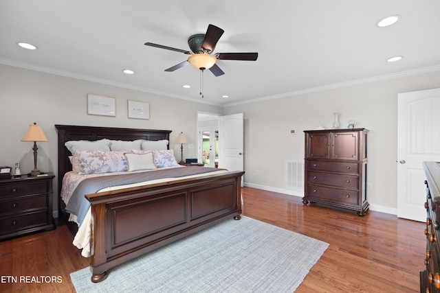 bedroom with ceiling fan, wood-type flooring, and ornamental molding