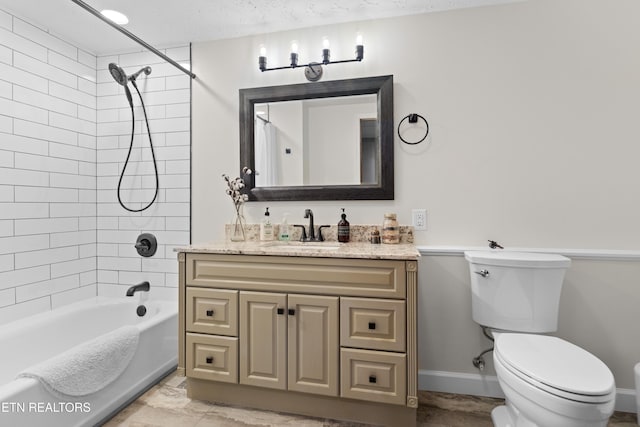 full bathroom with vanity, tiled shower / bath combo, toilet, and a textured ceiling