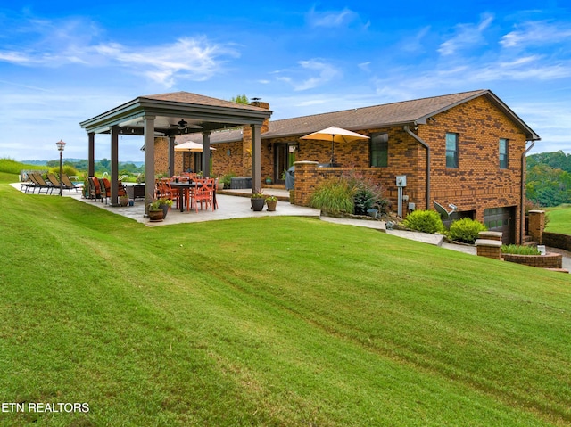 back of property featuring a yard, a patio area, and ceiling fan