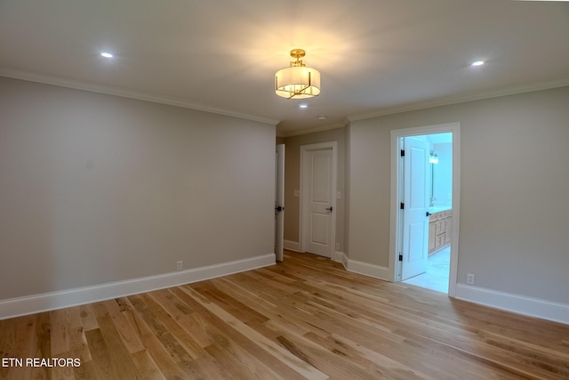 unfurnished room with light wood-style flooring, ornamental molding, baseboards, and recessed lighting