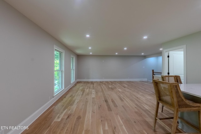 unfurnished dining area featuring light wood-style flooring, recessed lighting, and baseboards