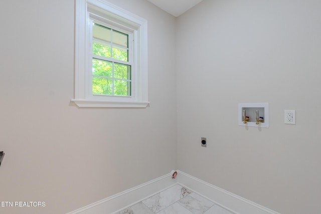 washroom featuring hookup for an electric dryer, light marble finish floors, washer hookup, and baseboards