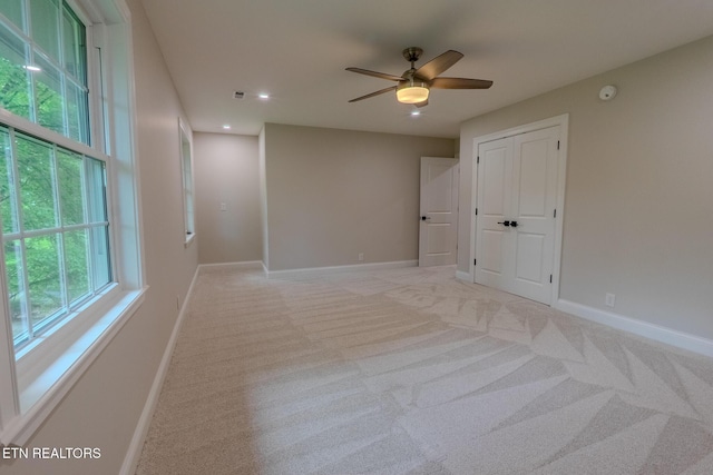 spare room with light carpet, baseboards, a ceiling fan, recessed lighting, and a smoke detector