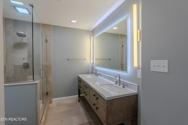 bathroom featuring a stall shower, double vanity, baseboards, and recessed lighting