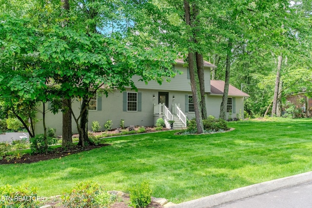 view of front of home with a front yard and stucco siding