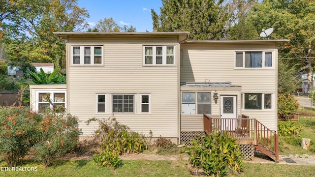 rear view of property featuring a deck