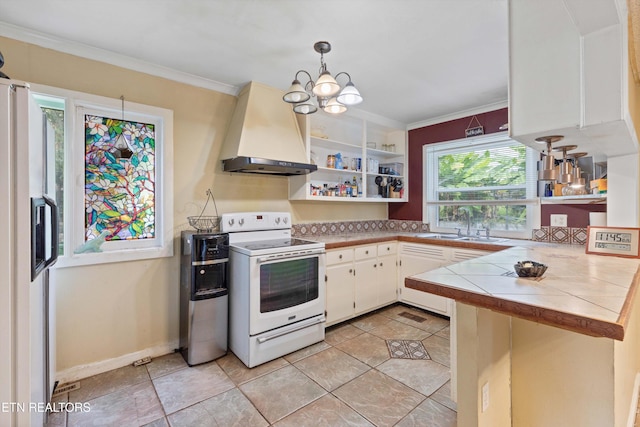 kitchen with white appliances, tile countertops, kitchen peninsula, white cabinetry, and extractor fan