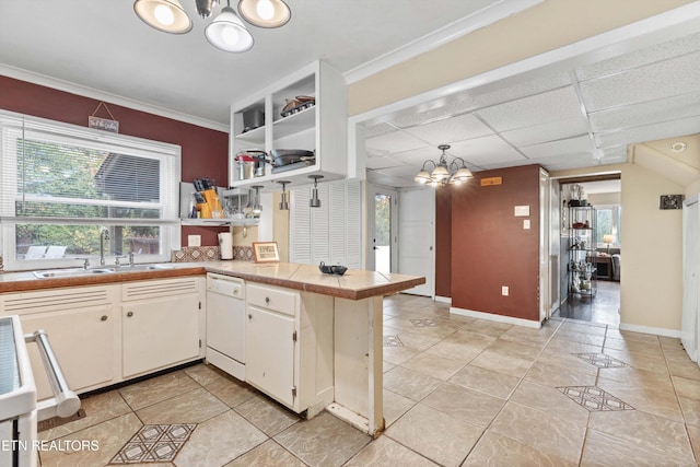 kitchen featuring sink, dishwasher, kitchen peninsula, white cabinetry, and a paneled ceiling