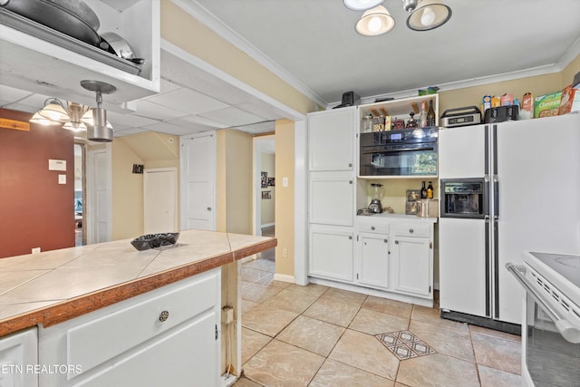 kitchen with ornamental molding, white cabinets, tile counters, and white appliances