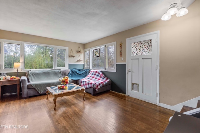 living room featuring a textured ceiling and dark hardwood / wood-style flooring