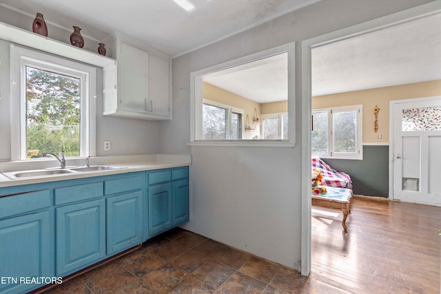 kitchen featuring blue cabinets, sink, and a wealth of natural light