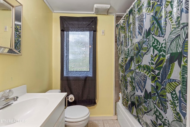 full bathroom with vanity, toilet, shower / bath combo with shower curtain, and tile patterned flooring