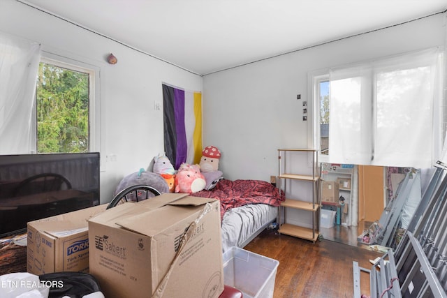 bedroom with dark hardwood / wood-style flooring