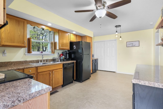 kitchen with decorative light fixtures, black appliances, sink, and ceiling fan