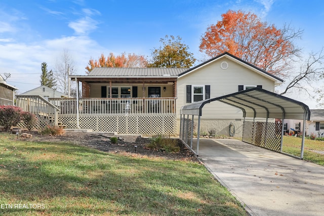 rear view of property featuring a yard, a carport, and a wooden deck