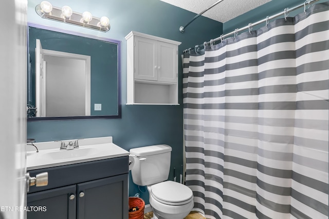 bathroom featuring vanity, curtained shower, a textured ceiling, and toilet