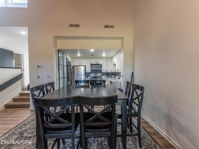 dining room with light hardwood / wood-style floors and sink