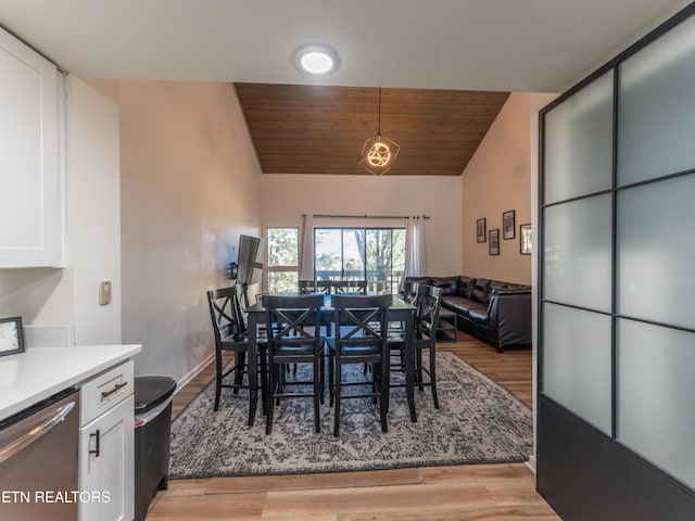 dining space featuring wood ceiling, light wood-type flooring, and vaulted ceiling